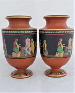 An antique pair of Prattware terracotta Grecian style urn shaped vases, decorated with a hand coloured polychrome enamel monochrome transfer printed pattern which has the name "Turkish Smokers" pattern.  This pattern is attributed to Felix and Richard Pratt, Fenton Potteries, High Street East, Fenton, Stoke on Trent Staffordshire, England. Circa 1860