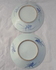 An antique pair of Chinese export porcelain dishes from the late 19th century - hand painted in cobalt  blue & white with a prunus blossom branch 28.5 cm diameter