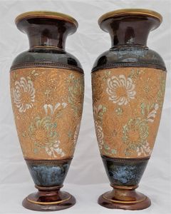 A beautiful pair of antique round baluster shaped Doulton Lambeth stoneware vases decorated with Doulton and Slater's patent technique using  impressed lace fabrics into the wet clay and later gilded and enamelled. 28 cm high total weight 2.242 kg unpacked.