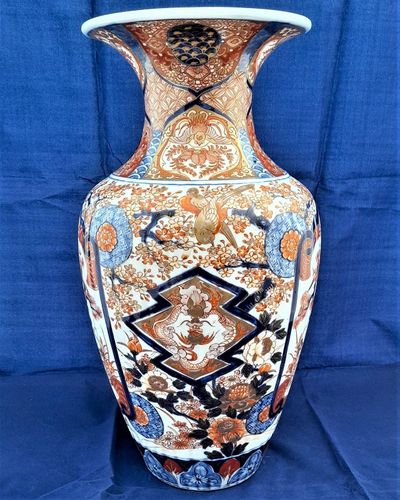 A large, 42.8 cm, Japanese Arita or Imari export porcelain baluster shaped vase with a ribbed body and flared trumpet neck, dating from the Meiji period in the latter half of the 19th century.