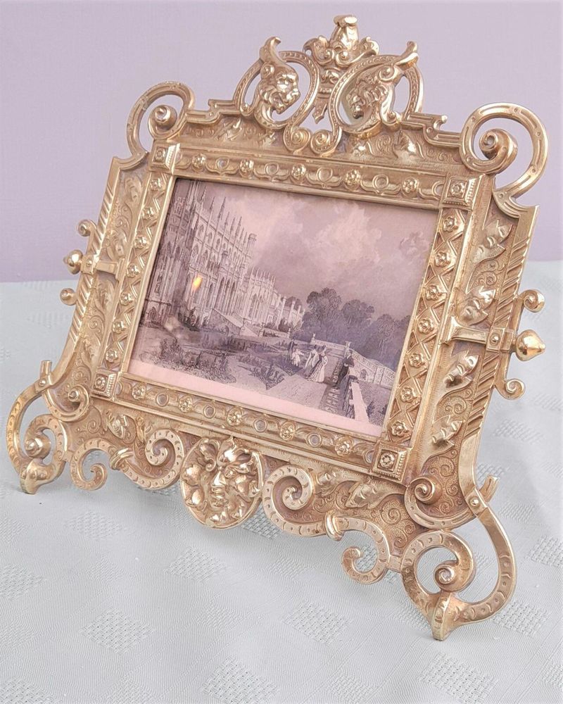 Antique Gothic Revival easel photo picture frame in high relief cast brass - decorated with helmeted leopards, the green man's head & ornate scrolls - for a landscape image size 6" x 4.5" - frame size 9" high, 10 inches wide by 8 inches deep, 19th century circa 1860. weighs 1156 grammes unpacked.
