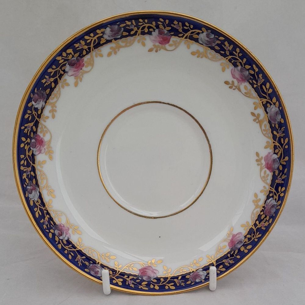 saucer on stand - Antique porcelain tea cup & saucer hand painted blue rim & swagged pink roses by W. Lambert 1915 - Larcombe King St Derby on a Bishop & Stonier Blank