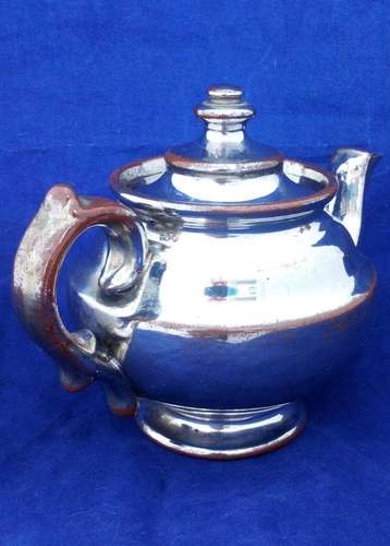 Victorian antique platinum lustre teapot with a shouldered round body on a pedestal foot and with a low collar, it is bachelor sized circa 1840