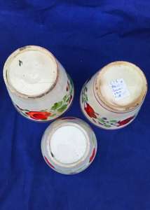 Three antique graduated pearlware and creamware pottery pink lustre ale beakers or cups with hand painted flowers circa 1820