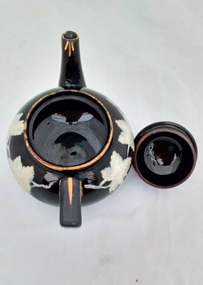 Victorian black glazed teapot with white enamelled vine leaves and stems antique circa 1850