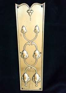 An antique Art Nouveau pressed or embossed brass finger plate for a door decorated with stylised seed pods original circa 1900.