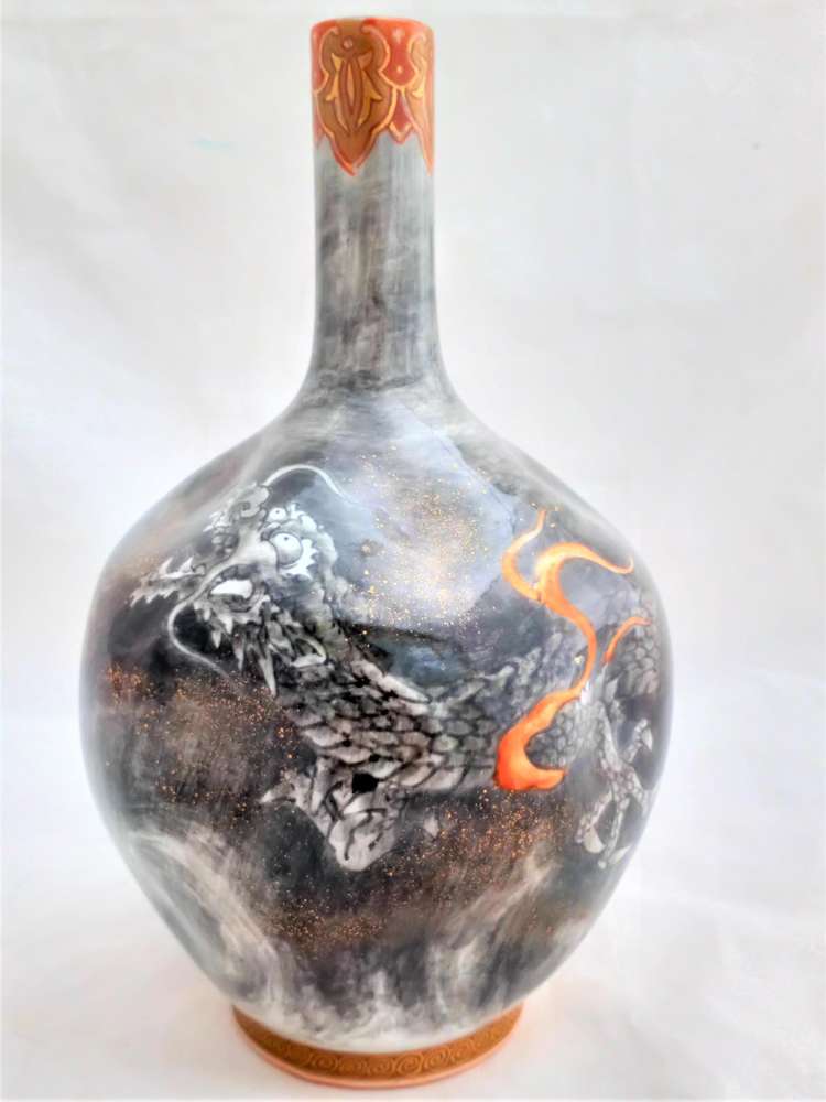 Antique Meiji period Japanese Koransha Fukagawa porcelain bottle vase with dimpled sides decorated with a dragon in swirling clouds in greys and blacks (En Grisaille) circa 1880.