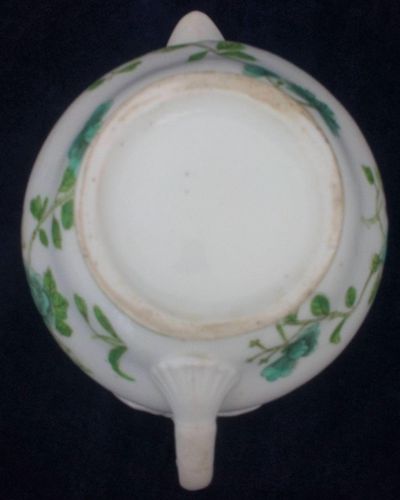 Antique low round porcelain creamer or milk jug made by John Rose of  Coalport Porcelain Works with transfer printed and hand coloured turquoise and green flowers pattern. Dates to circa 1820.