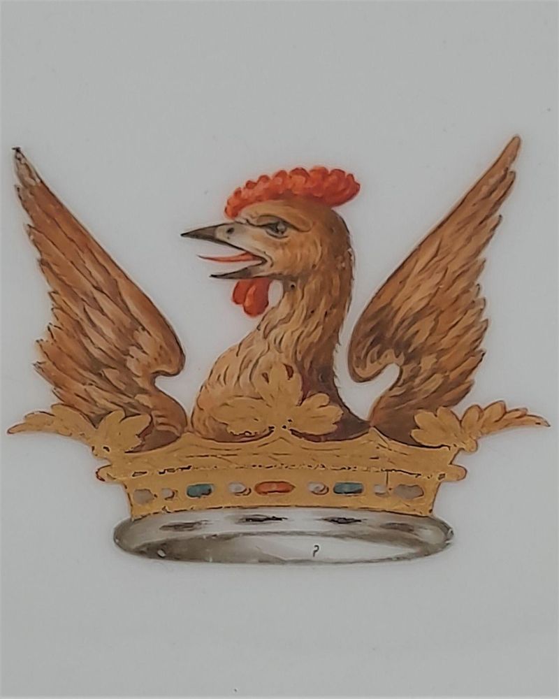 A very decorative 19th century armorial porcelain plate emblazoned with an heraldic crest for the family name Bellam, alternative spelling that the crest is also applicable to : Ballam, Bellome or Bellam .  A Heraldic description of the crest : Out Of A Ducal Coronet Or, A Cock's Head Between Two Wings Gu., Combed And Wattled Of The First.    The plate has an ornate under-glaze mazarine blue ground border and and gilded lobed rim which has an outer peach and gilded rococo scroll border. This beautiful quality plate dates from the mid 19th century circa 1850, the underside is unmarked without any maker's mark.