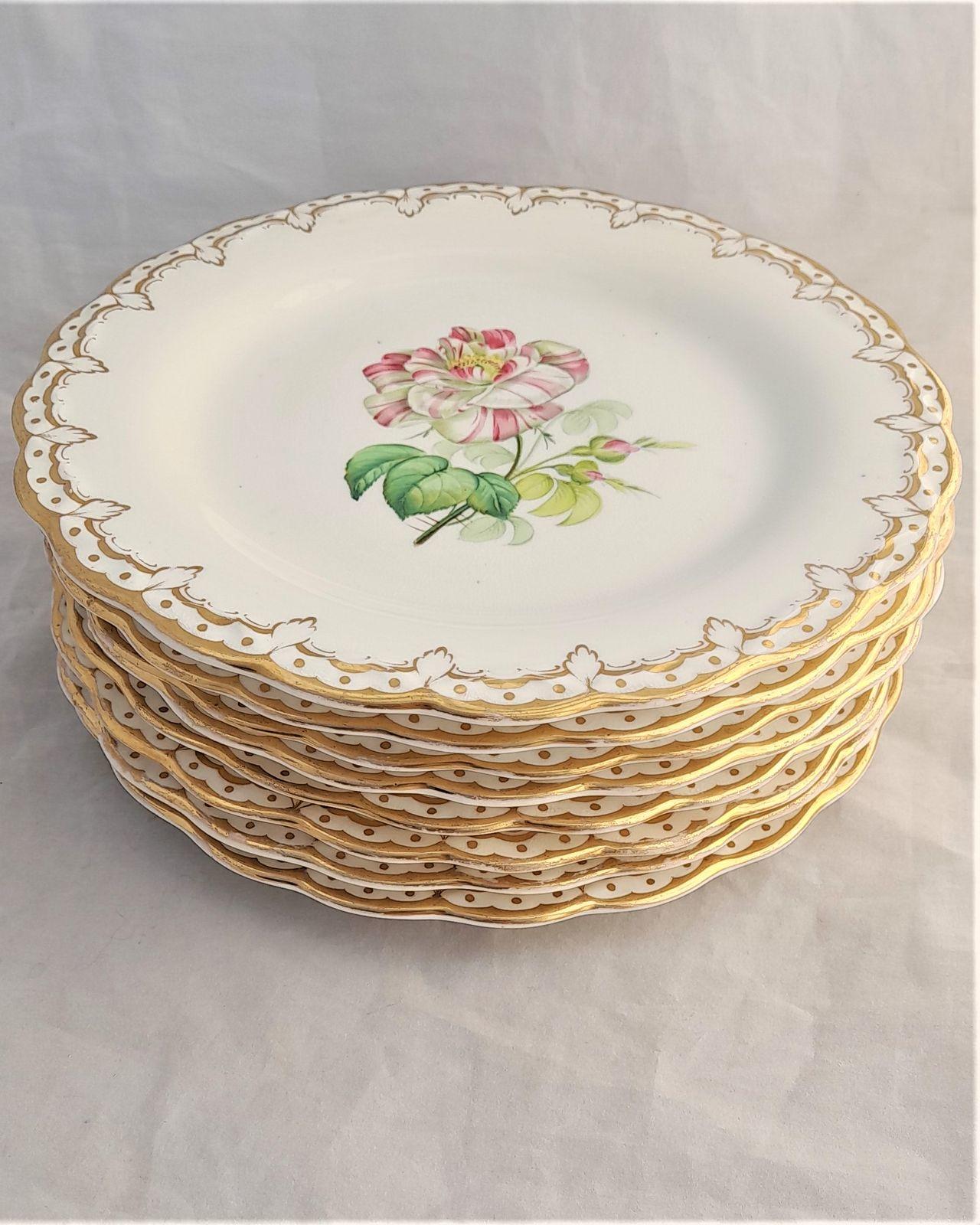 A decorative set of eight antique porcelain botanical dessert plates each hand painted with different flowers, scalloped rim with gilt leaf shaped border pattern Victorian circa 1850 iron red hand painted pattern number 1060. 22 cm diameter 2.2 cm high. The eight plates weigh 2.9 kgs unpacked.