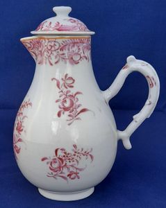 An antique Chinese porcelain lidded sparrow beak milk jug or creamer hand painted in puce with a floral pattern made in theperiod of the Chinese Emperor Qianlong in the Qing dynasty  circa 1760