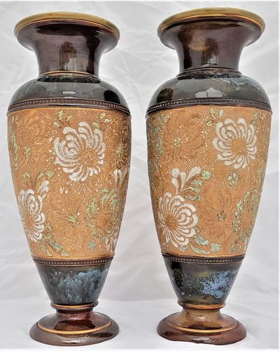 A beautiful pair of antique round baluster shaped Doulton Lambeth stoneware vases decorated with Doulton and Slater's patent technique using  impressed lace fabrics into the wet clay and later gilded and enamelled. 28 cm high total weight 2.242 kg unpacked.