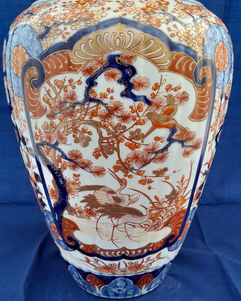 A large, 42.8 cm, Japanese Arita or Imari export porcelain baluster shaped vase with a ribbed body and flared trumpet neck, dating from the Meiji period in the latter half of the 19th century.