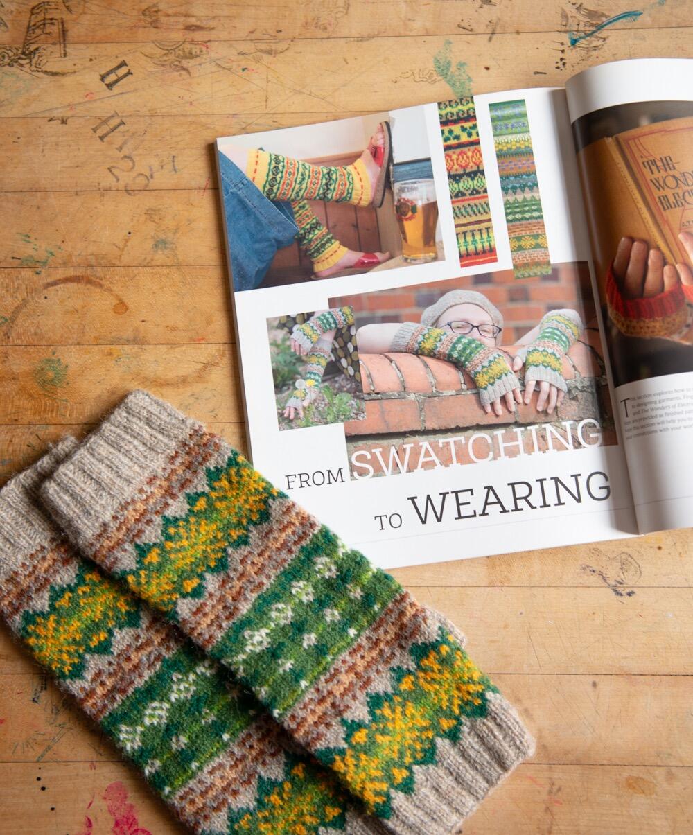 KNITSONIK Stranded Colourwork open on a table on a page about taking ideas from swatching forward into knitted garments; the knitted mitts from this section are displayed on the table beside the book