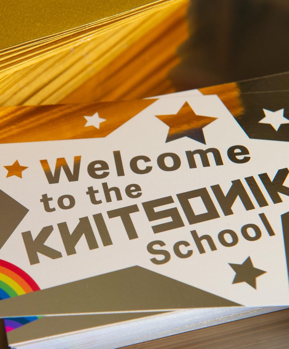 Welcome to the KNITSONIK School - golden foiled ticket, pictured beside golden envelopes