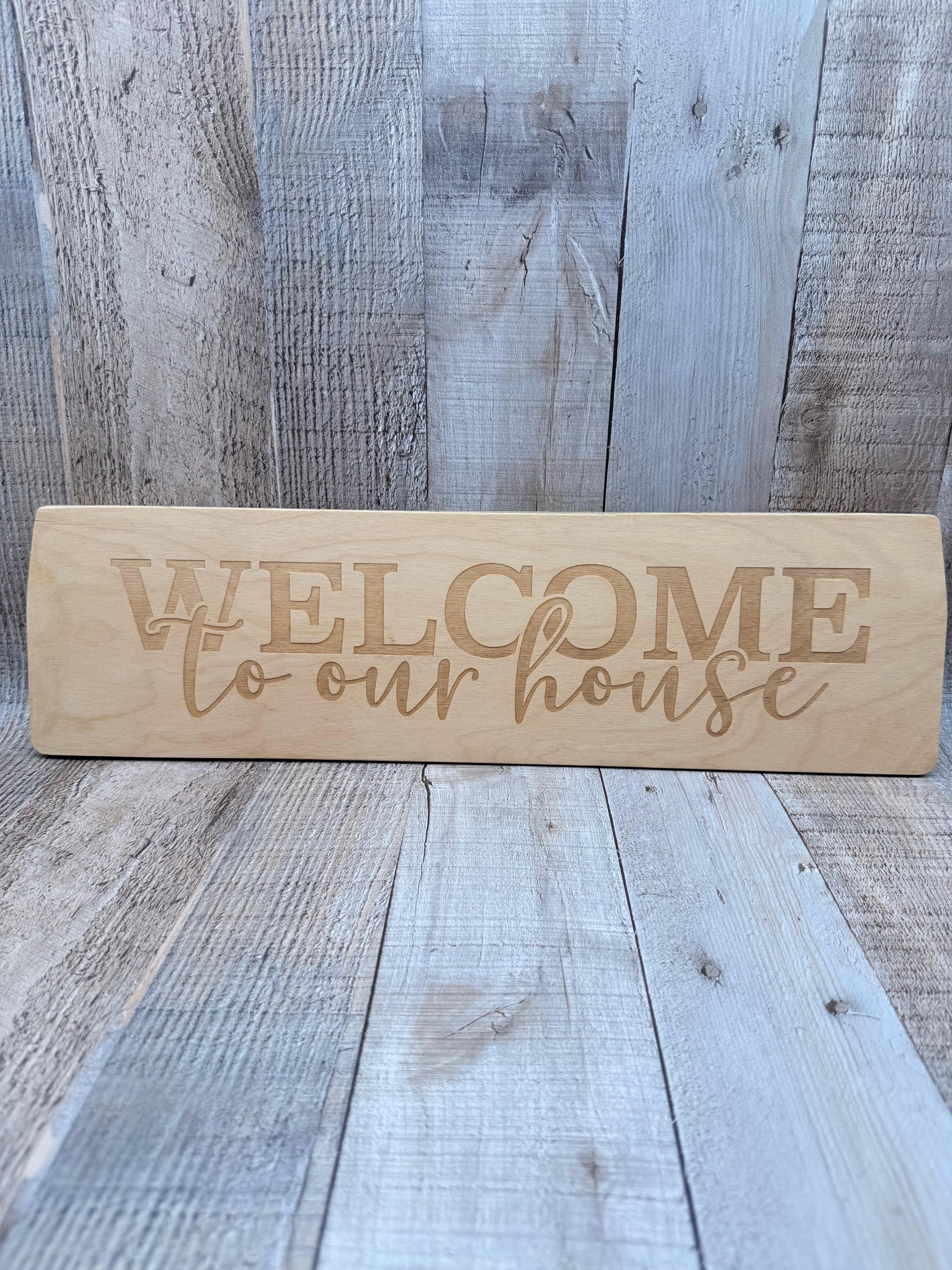 WELCOME TO OUR HOUSE LASER ENGRAVED BEECH WALL SIGN