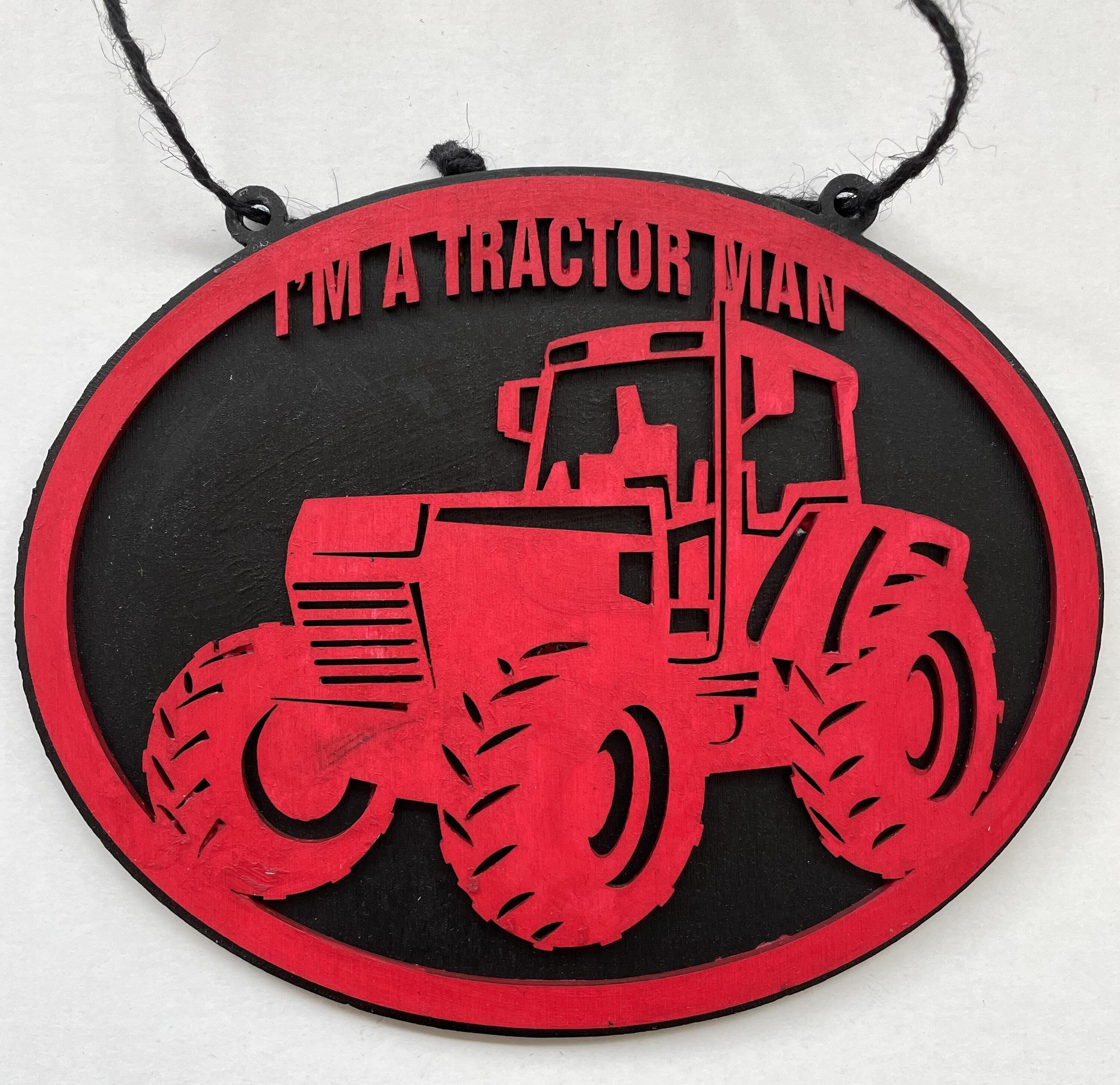 Black sign with red tractor