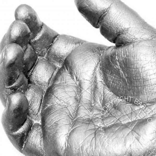Close up of skin details on a silver painted hand cast
