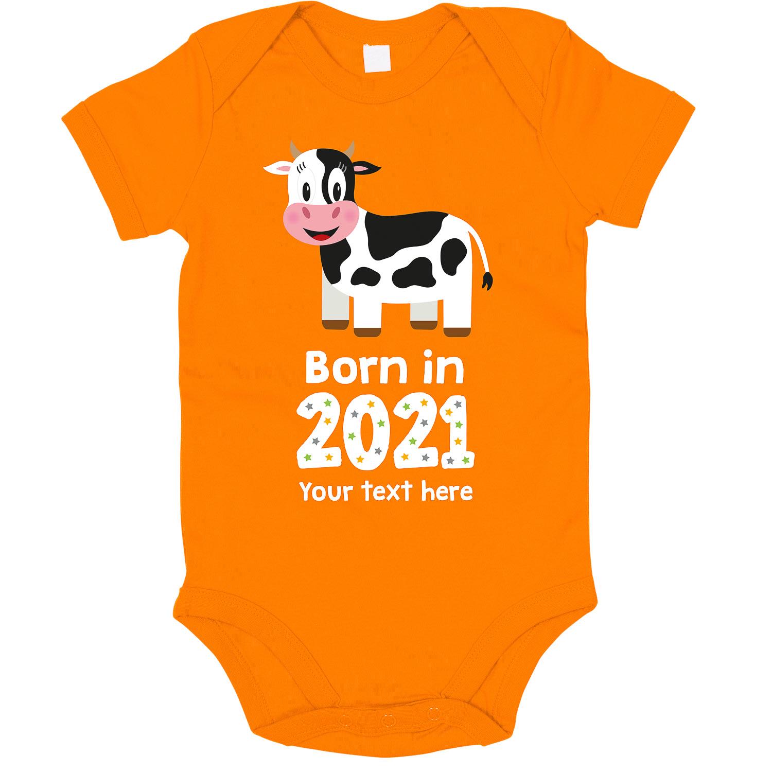 Anismalls cow character on an orange coloured personalised bodysuit with born in 2021 text in white