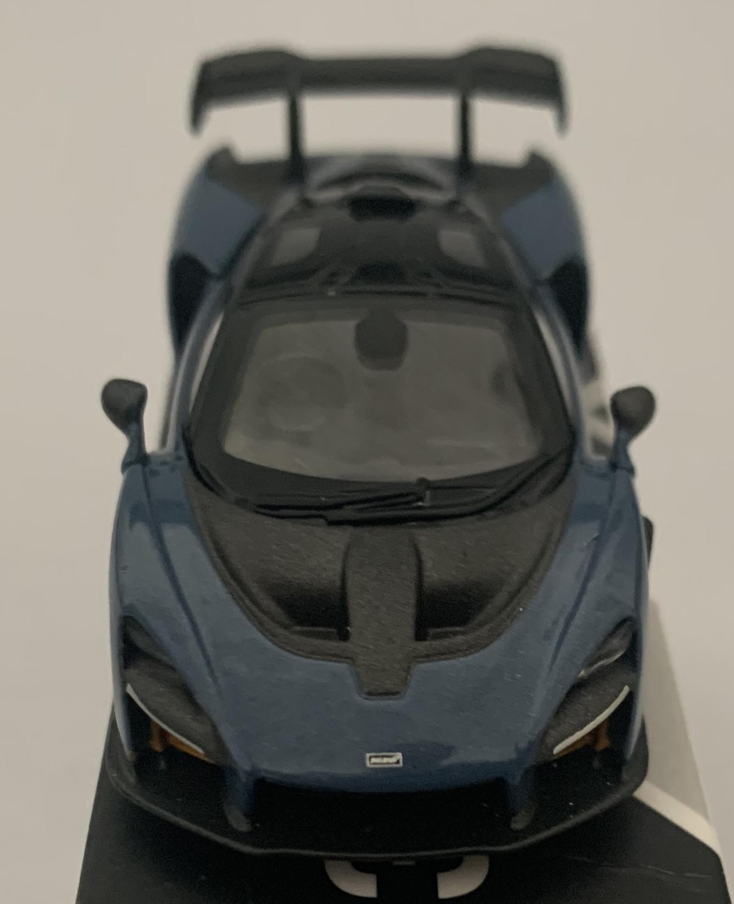 An excellent scale model of a McLaren Senna decorated in victory grey with black roof  and silver wheels.  Other trims are finished in black and yellow