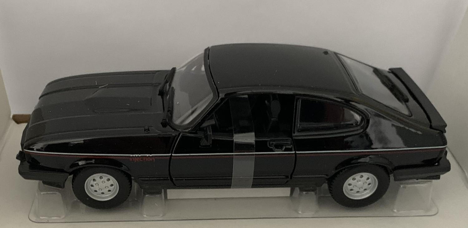 An excellent scale model of a Ford Capri 2.8 Injection decorated in black with authentic graphics, rear spoiler and silver wheels