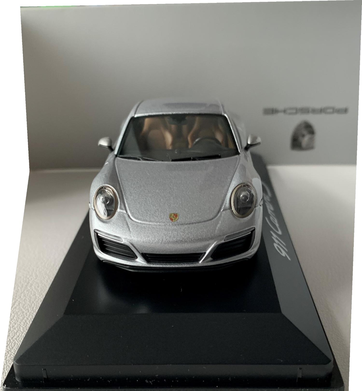 An excellent reproduction of the Porsche 911 Carrera S Coupe with detail throughout, all authentically recreated. Model is mounted on a removable plinth with a removable hard plastic cover and presented in Porsche packaging
