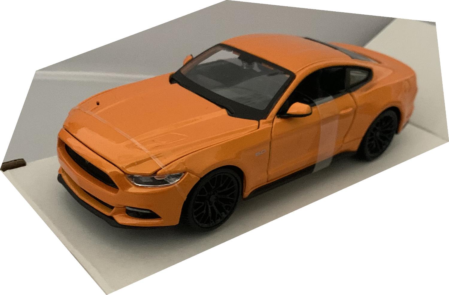 An excellent scale model of a Ford Mustang GT decorated in metallic orange with black wheels.