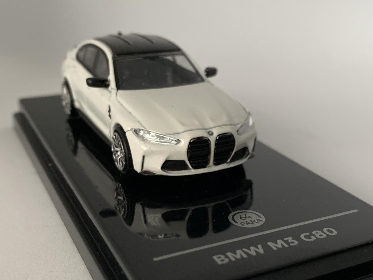 An excellent scale model of a BMW M3 G80 decorated in white with black roof, rear spoile