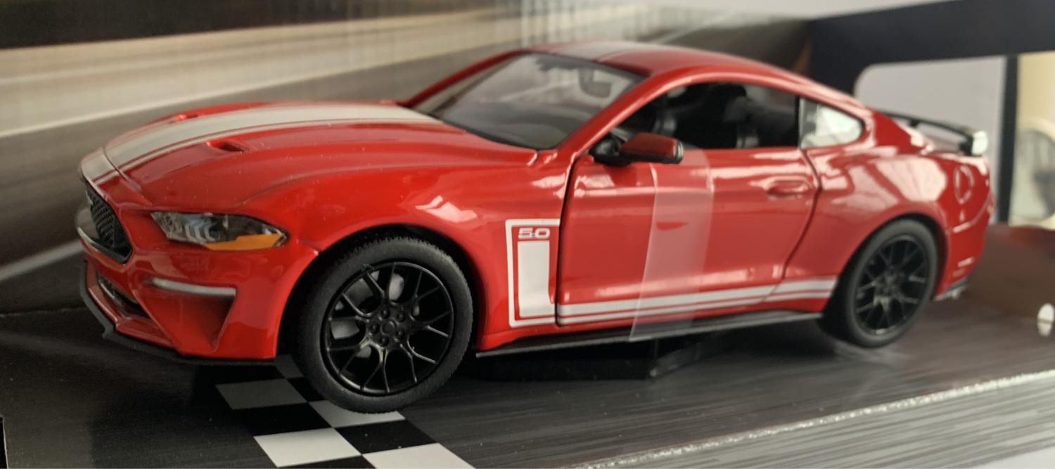 An excellent scale model of a Ford Mustang 5.0 GT decorated in red with authentic graphics, rear spoiler and black wheels.