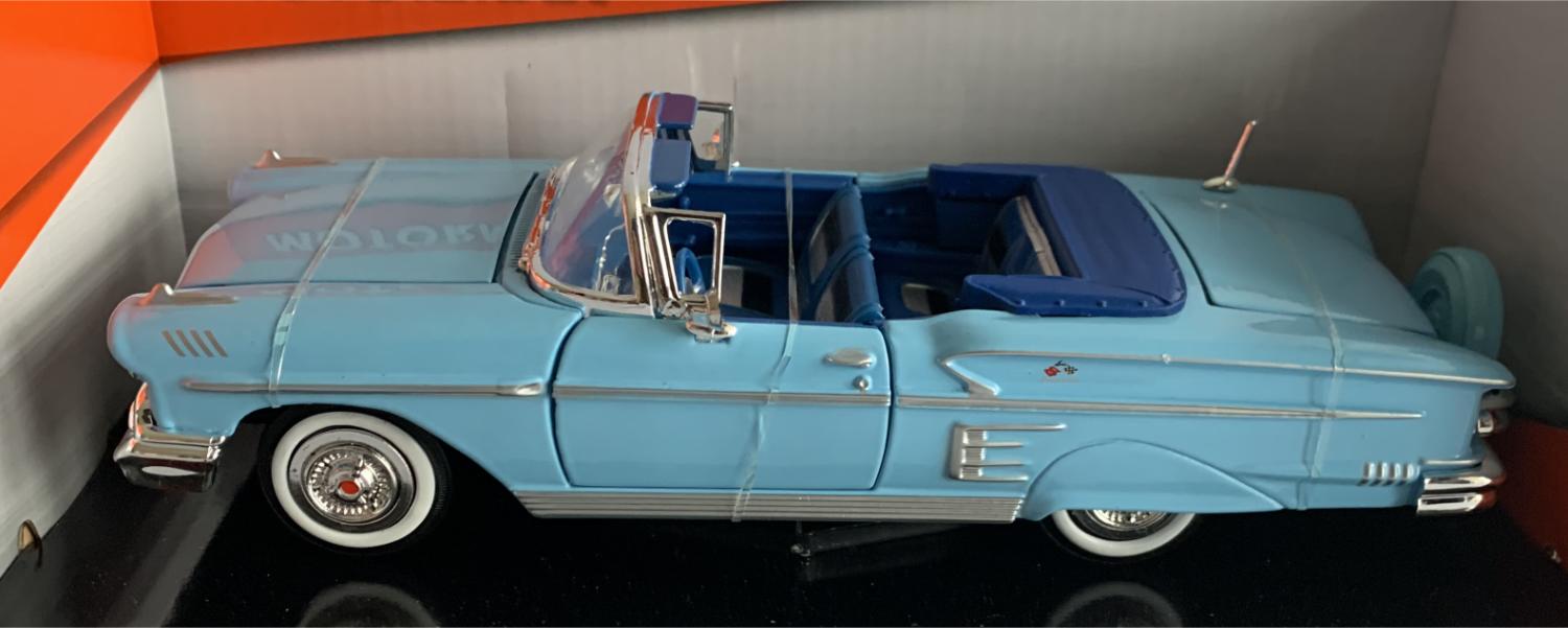 An excellent scale model of a Chevrolet Impala Convertible decorated in light blue with chrome wheels and white walled tyres.