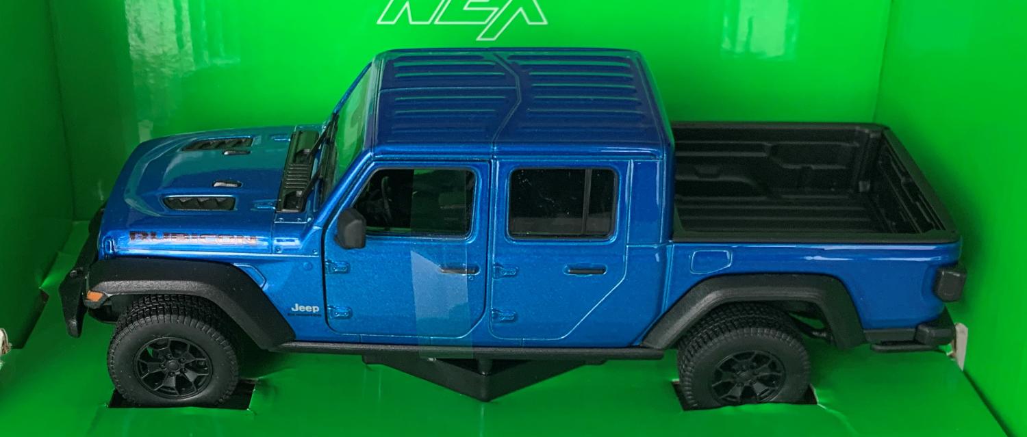 An excellent scale model of a Jeep Gladiator Rubicon decorated in metallic blue with authentic graphics and black wheels