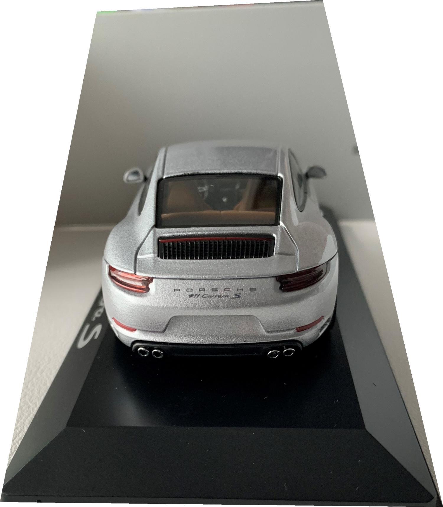 An excellent reproduction of the Porsche 911 Carrera S Coupe with detail throughout, all authentically recreated. Model is mounted on a removable plinth with a removable hard plastic cover and presented in Porsche packaging