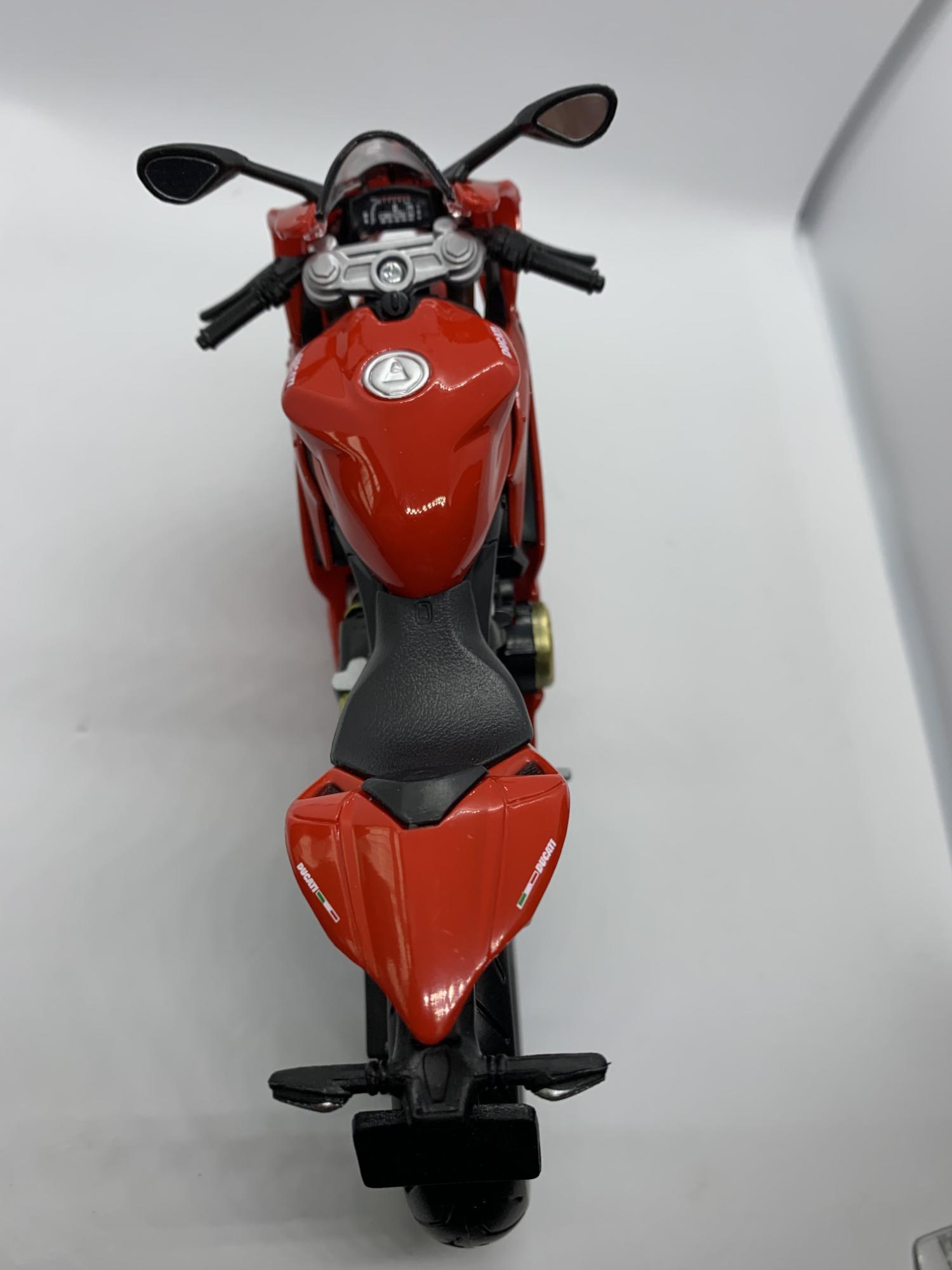 A good scale model of a Ducati 1199 Panigale from 2012 decorated in red with authentic graphics