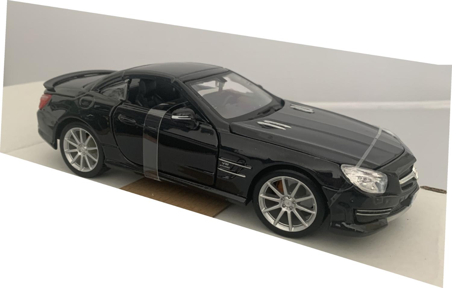An excellent scale model of a Mercedes Benz SL 65 AMG decorated in black with rear spoiler and silver wheels.  Other trims are finished in chrome and silver.