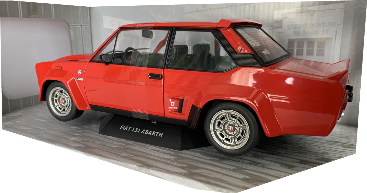 A very good representation of the Fiat 131 Abarth decorated in red with rear spoiler, bonnet air vent and dark grey wheels