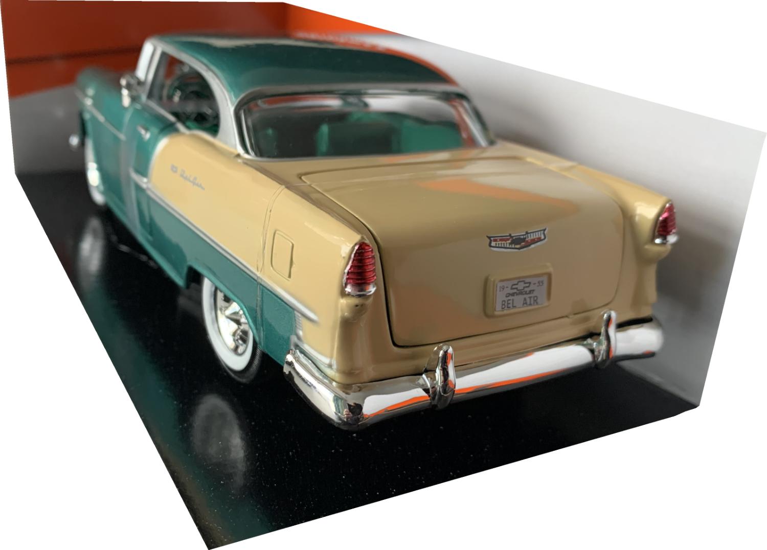 An excellent scale model of a Chevrolet Bel Air Hard Top decorated in metallic green and beige with green interior and chrome steering wheel.  Features include opening driver and passenger doors, opening bonne