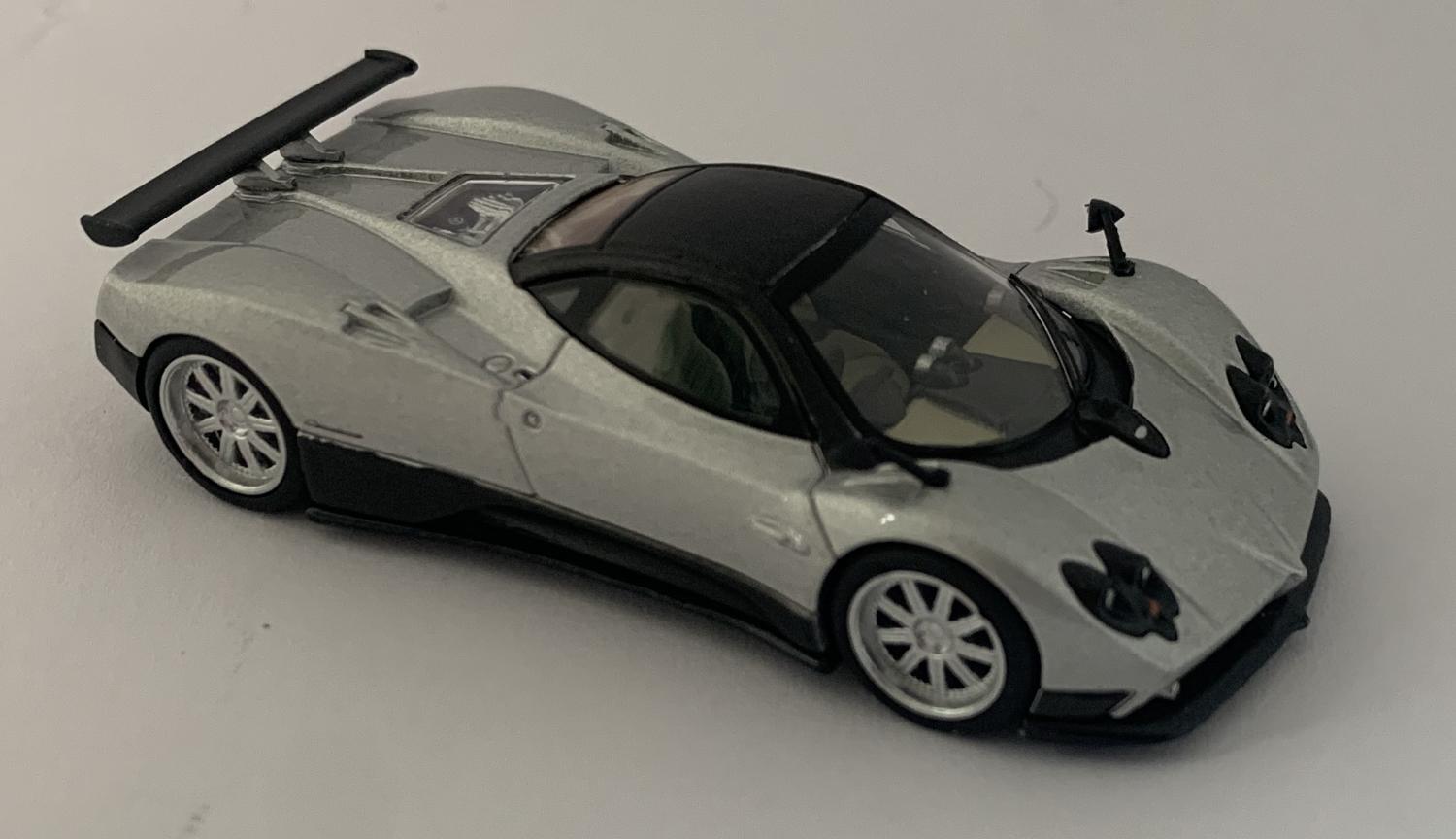 An excellent scale model of a Pagani Zonda F decorated in silver with high rear spoiler and silver wheels.