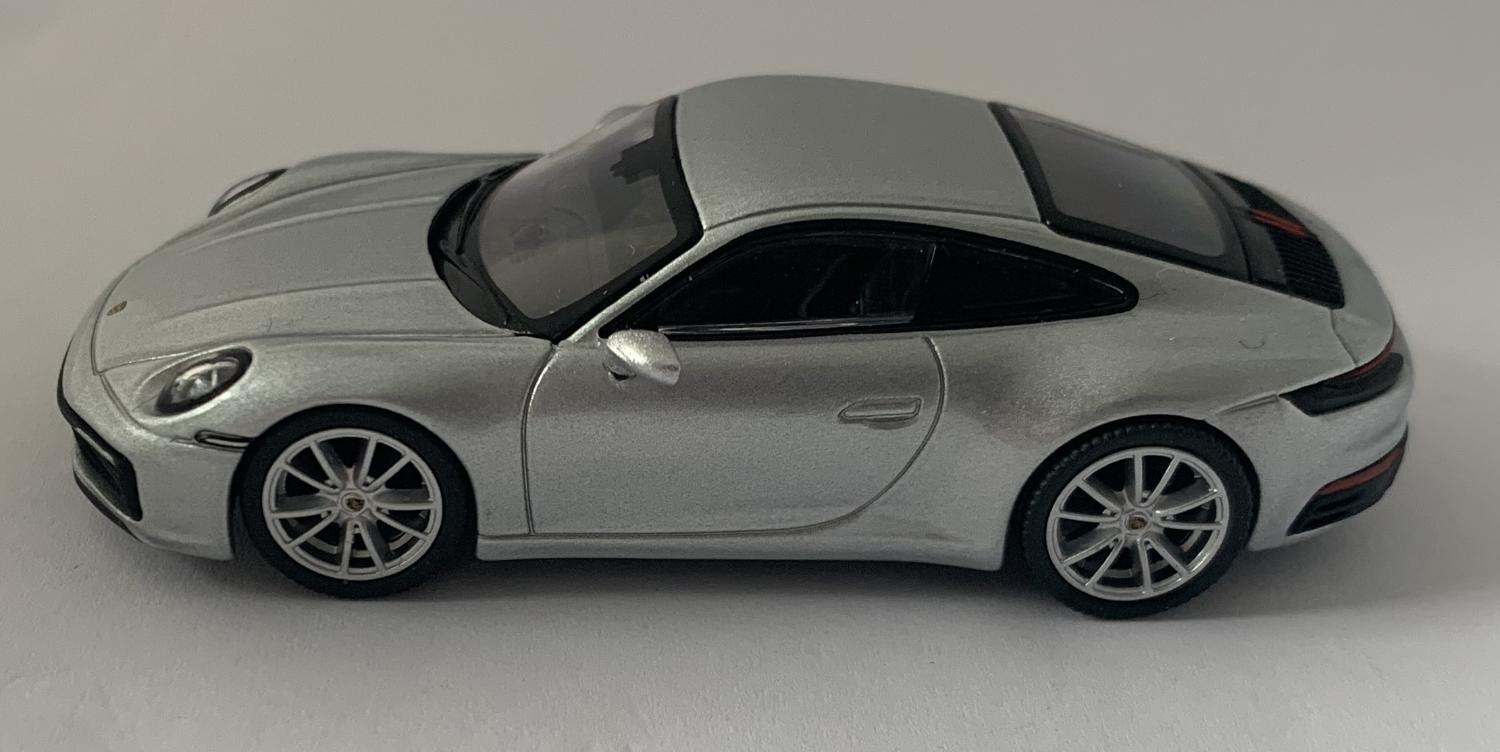 An excellent scale model of a Porsche 911 Carrera 4S decorated in silver metallic with silver wheels