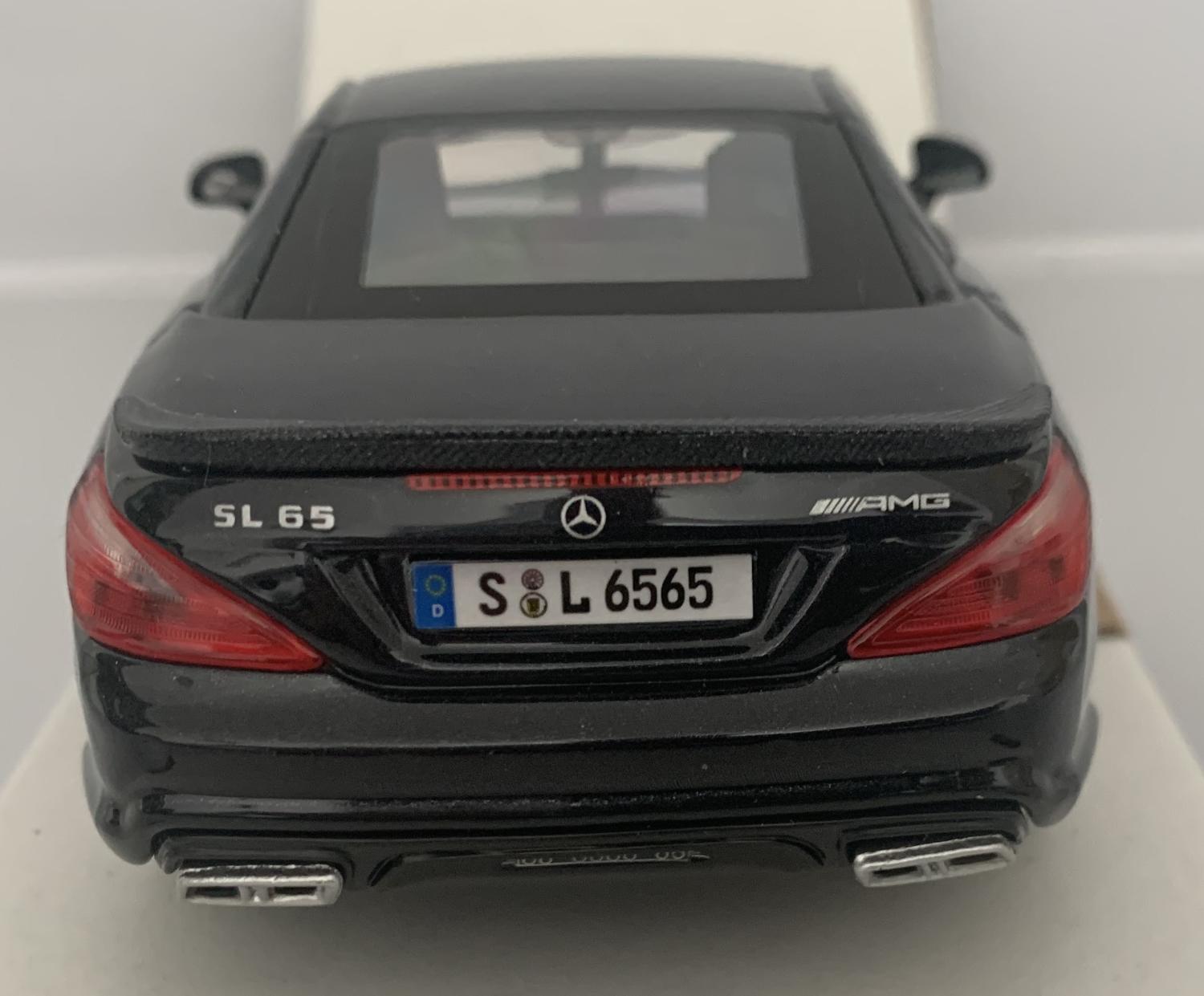 An excellent scale model of a Mercedes Benz SL 65 AMG decorated in black with rear spoiler and silver wheels.  Other trims are finished in chrome and silver.