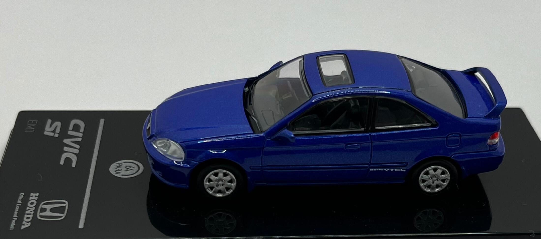 An excellent scale model of a 1999 Honda Civic Si decorated in electron blue pearl with high rear spoiler, sunroof and silver wheels.