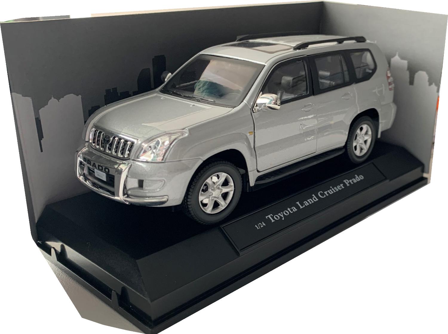A very good scale model of a Toyota Land Cruiser Prado decorated in silver with sunroof, roof rails, spare wheel on rear door