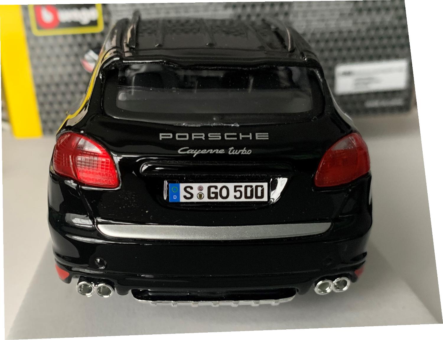 An excellent scale model of a Porsche Cayenne Turbo decorated in black with sunroof, roof rails, rear top spoiler and silver wheels.