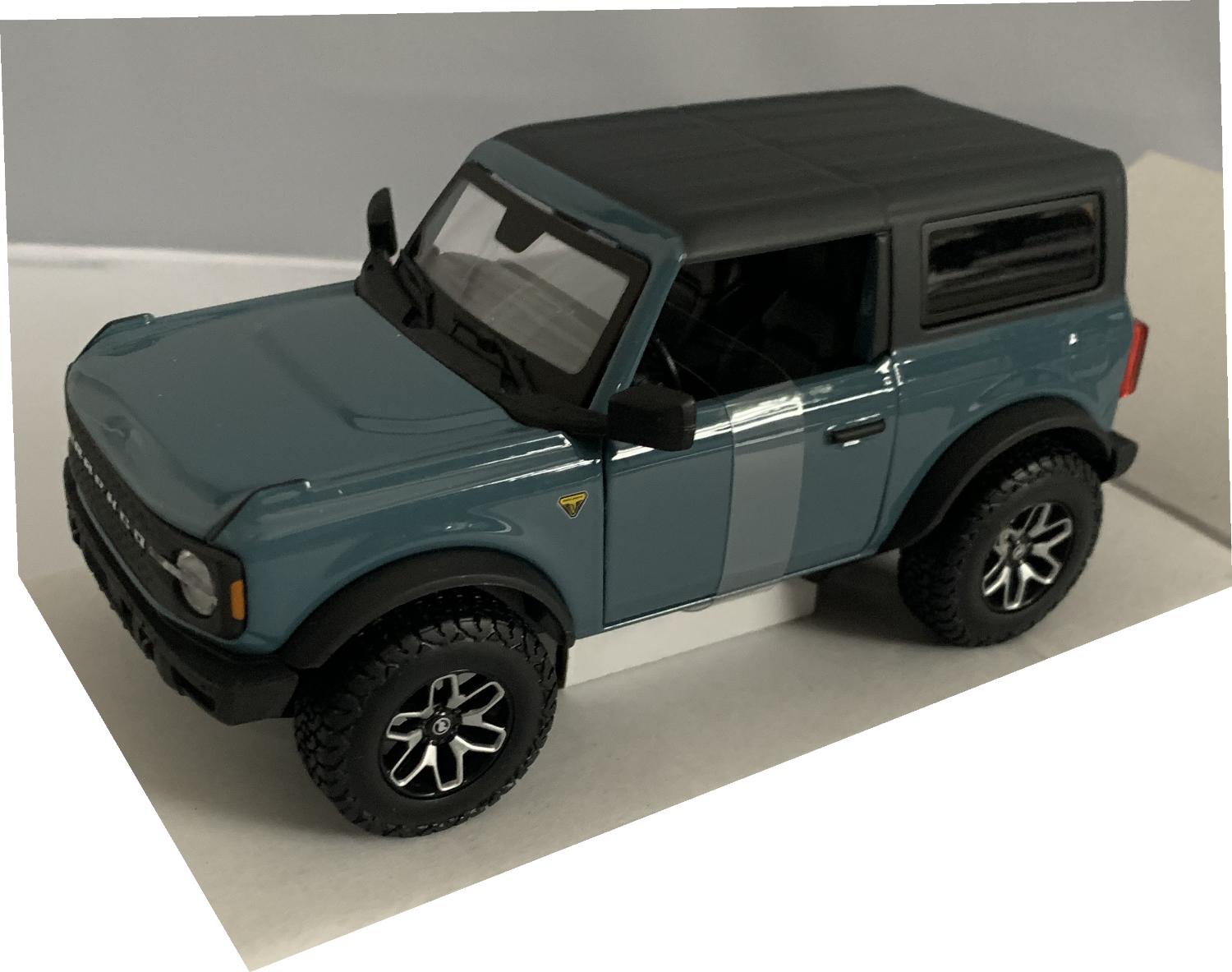 An excellent scale model of a Ford Bronco Badlands decorated in blue with black roof and silver and black wheels.