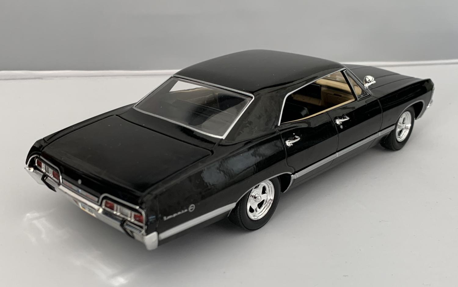 An excellent scale model of a Chevrolet Impala Sport Sedan decorated in black with chrome wheel