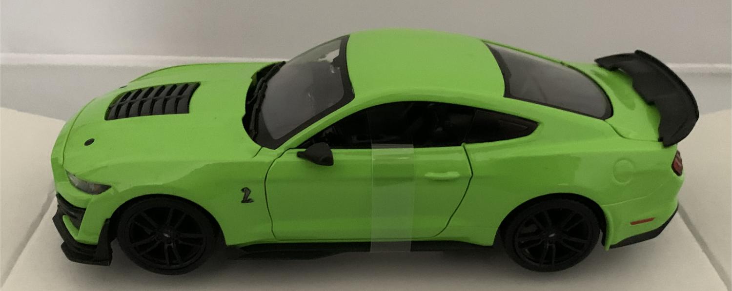 An excellent scale model of a Ford Mustang Shelby GT500 decorated in green with rear spoiler and black wheels