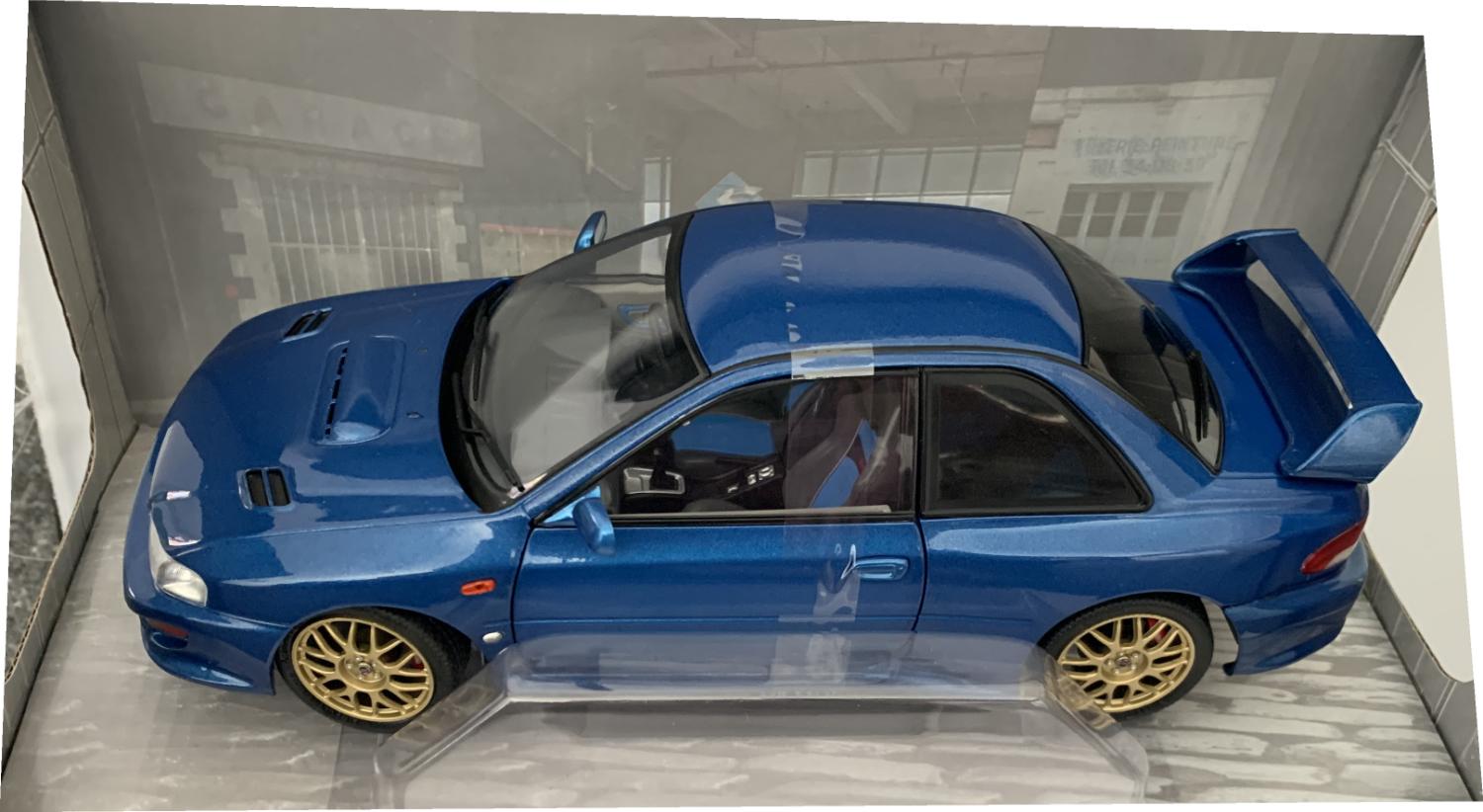 A very good representation of the Subaru Impreza 22B STi Version decorated in sonic blue with high rear spoiler, bonnet air vents, blacked out rear windows and gold wheels