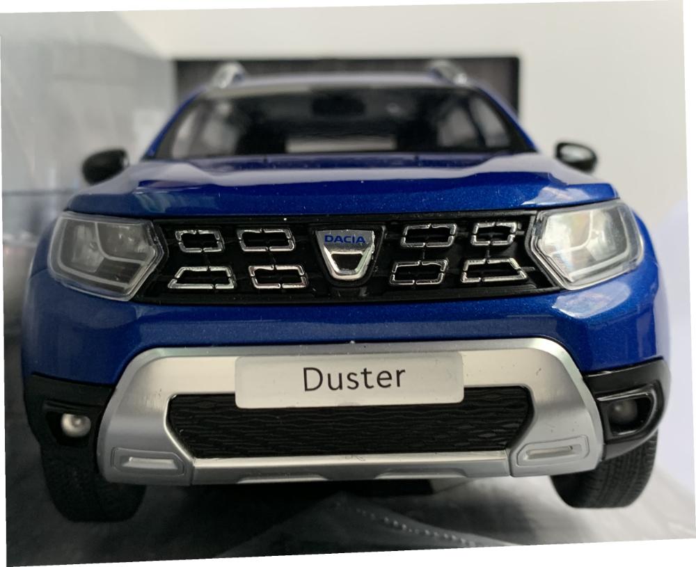 A very good representation of the Dacia Duster decorated in blue cosmos with roof rails, blacked out rear windows with chrome and black wheels. Features include working wheels, opening driver and passenger doors