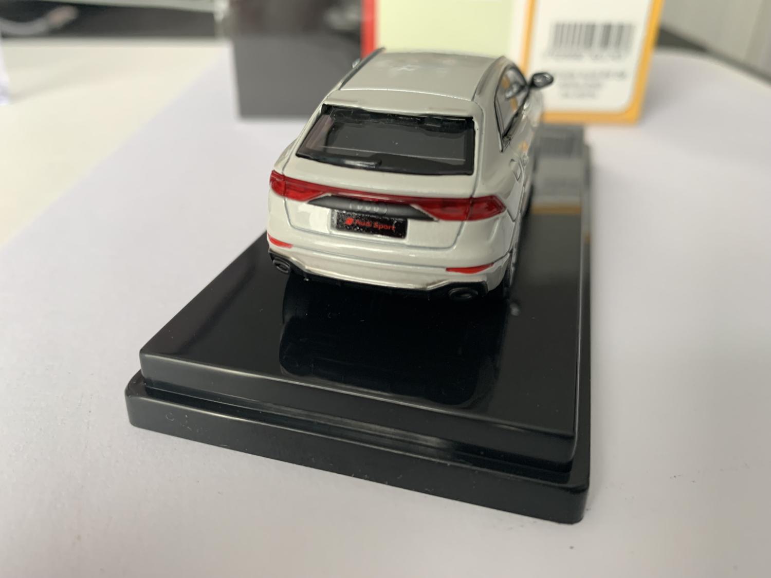 n excellent scale model of an Audi RS Q8 decorated in white with roof top spoiler, roof rails and silver wheels.