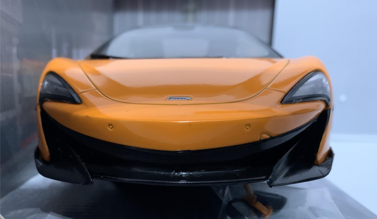 A very good representation of the McLaren 600LT decorated in orange with black roof, rear spoiler
