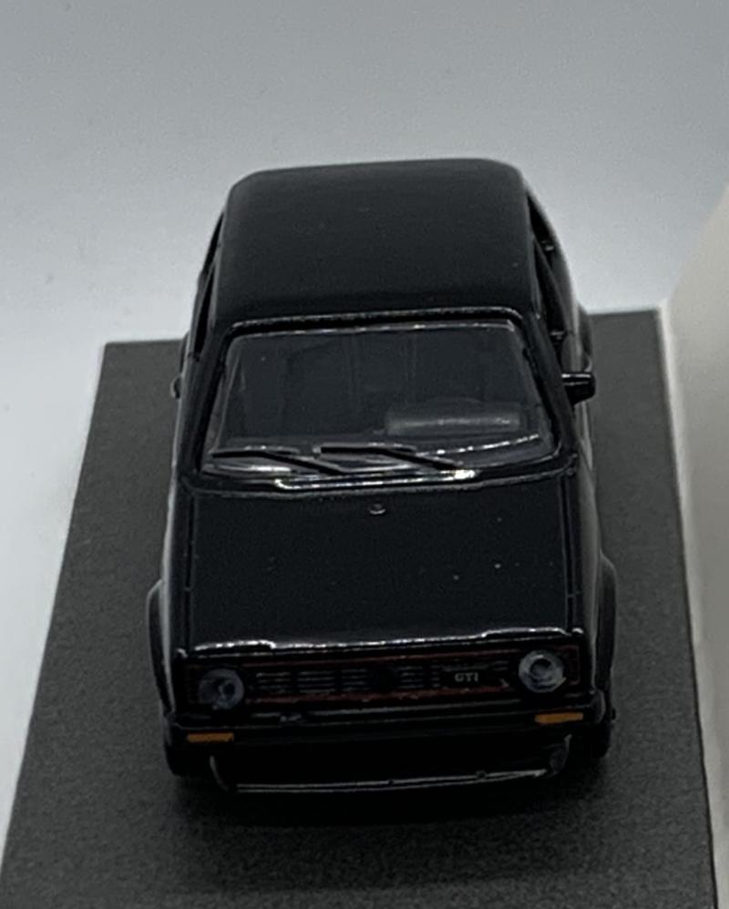 An excellent scale model of a VW Golf GTI decorated in black with silver strips and silver wheel